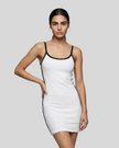 Mid body front view of a woman wearing the Athlesi TrackLine Contour Dress in white
