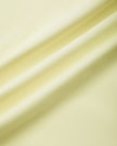 Closeup of the lightweight stretch performance fabric used in the TrackLine Contour Yoga Leggings in Light Yellow (White)