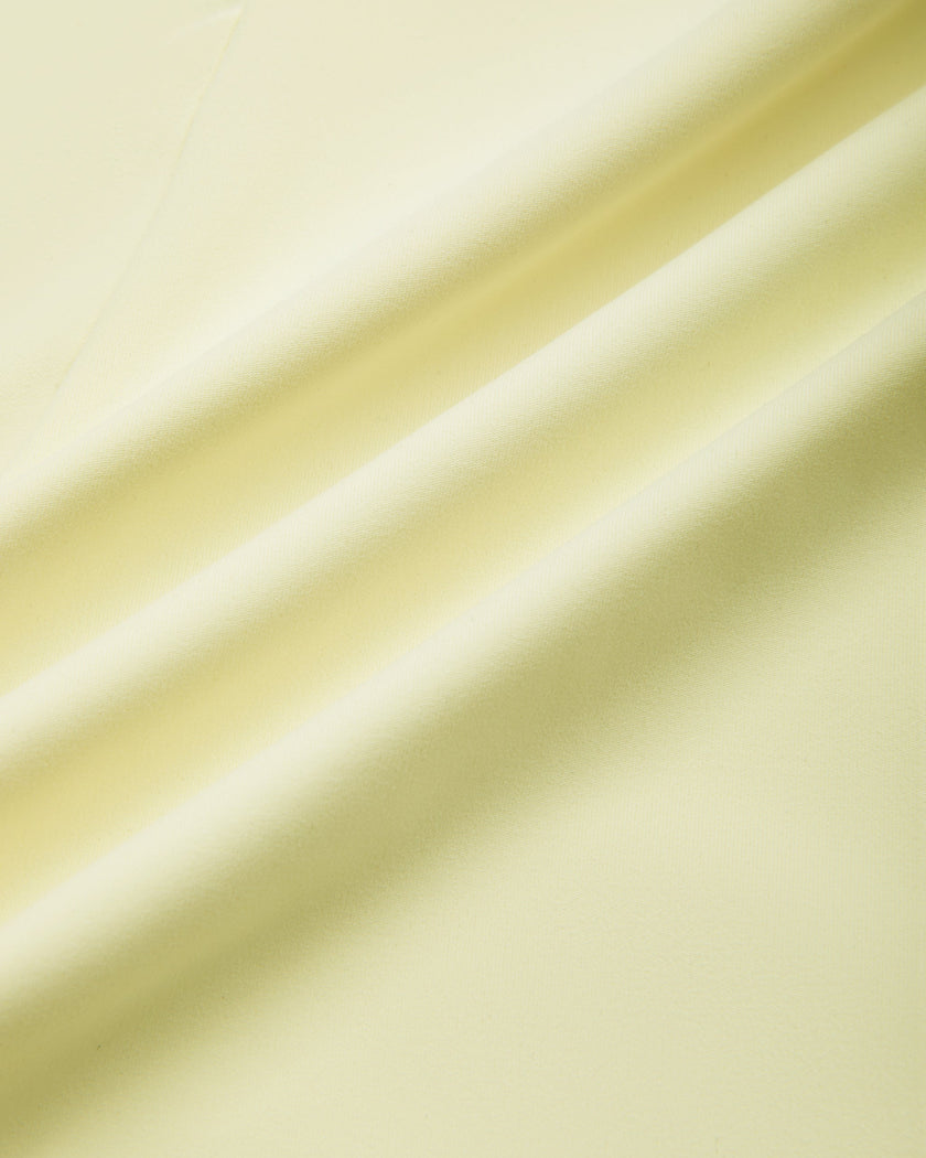 Closeup of the lightweight stretch performance fabric used in the TrackLine Contour Yoga Leggings in Light Yellow (White)