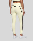 Model wearing the TrackLine Contour Yoga Leggings in Light Yellow (White), back view