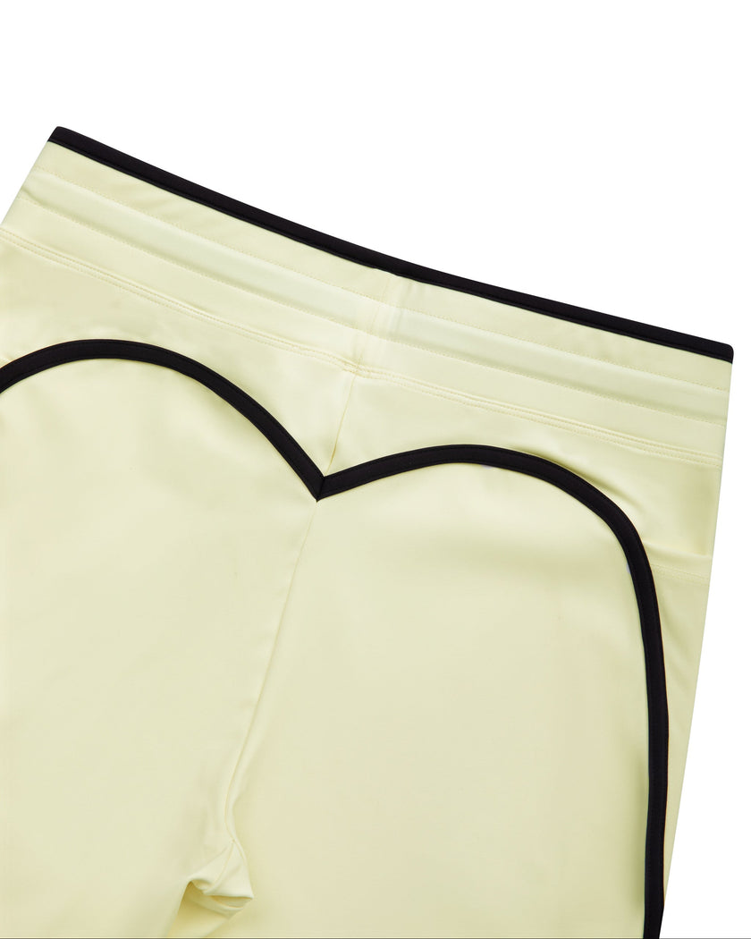 Closeup of the back waistband and contour seam detail on the TrackLine Contour Yoga Leggings in Light Yellow (White)