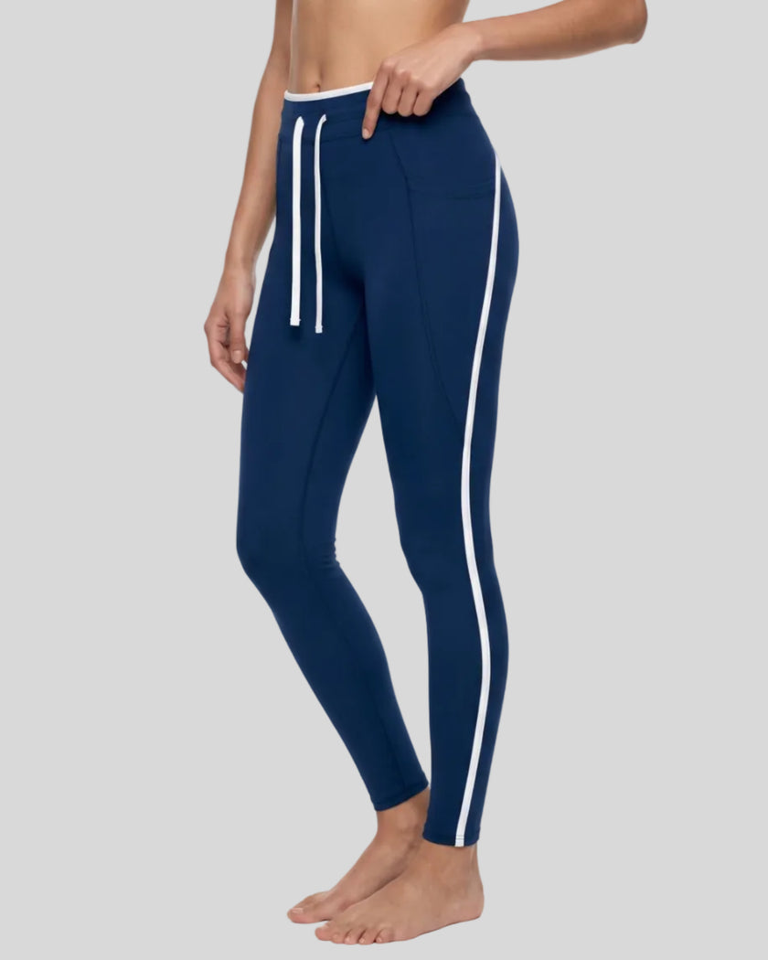 Model wearing the TrackLine Contour Yoga Leggings in Navy Blue, side angle view