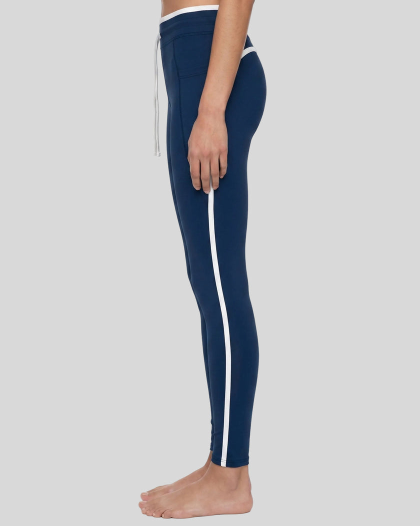 Model wearing the TrackLine Contour Yoga Leggings in Navy Blue, side view