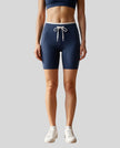 Model wearing the TrackLine Contour Yoga Shorts in Navy Blue, front view