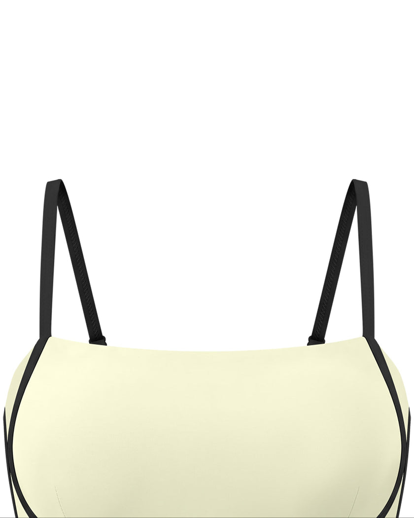 Closeup of the U-neckline and contrast contour detailing on the TrackLine Contour Yoga Sports Bra in White.