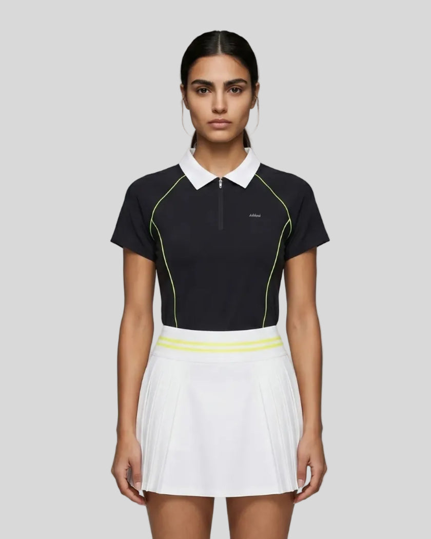 Female model wearing the TrackLine Court Polo in Black viewed from the front.