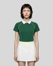 Female model wearing the TrackLine Court Polo in Blackish Green viewed from the front