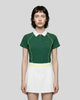 Female model wearing the TrackLine Court Polo in Blackish Green viewed from the front