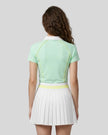 Back view of a female model wearing the TrackLine Court Polo in Mint Green.
