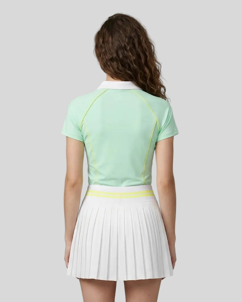 Back view of a female model wearing the TrackLine Court Polo in Mint Green.