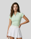 Female model wearing the TrackLine Court Polo in Mint Green viewed from the front.