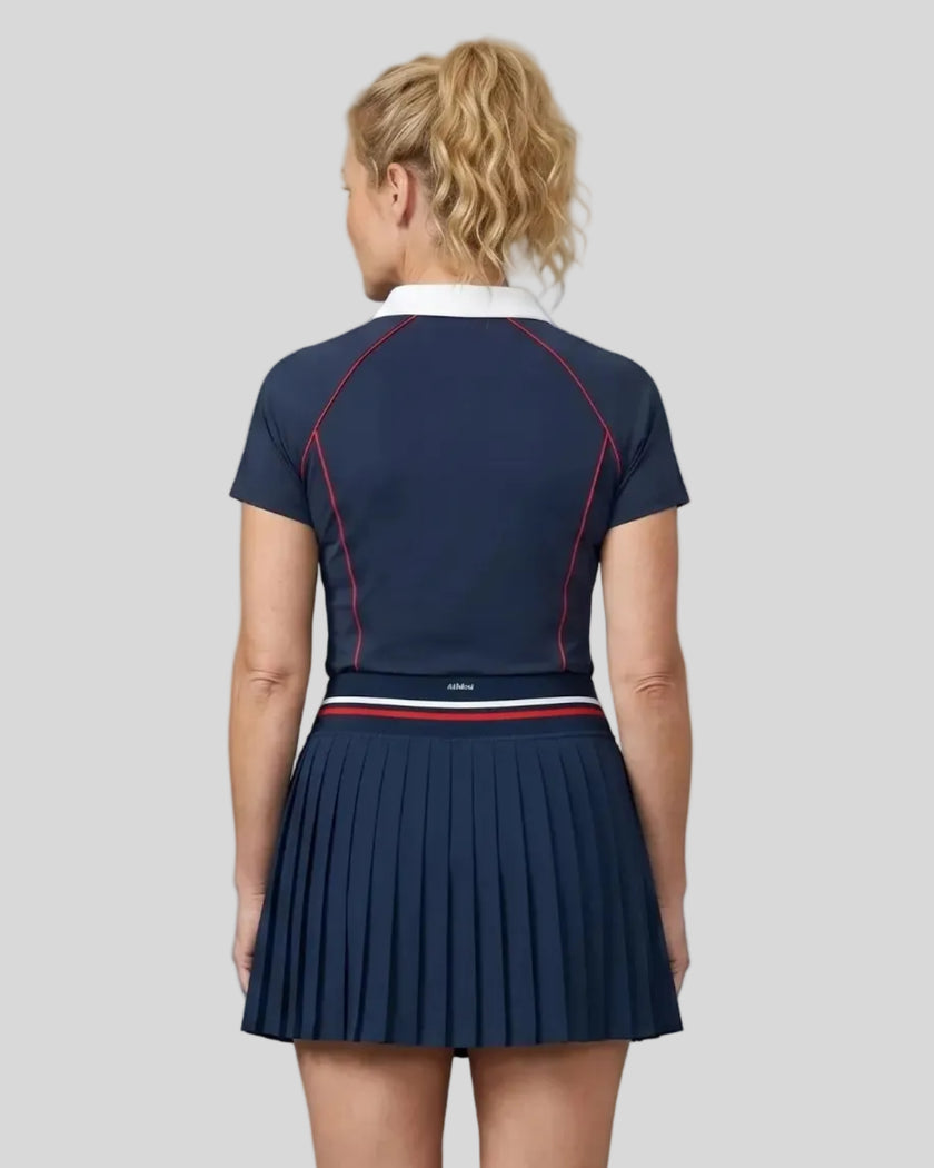 Back view of a female model wearing the TrackLine Court Polo in Navy Blue (size large)