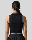 Back view of a model wearing the TrackLine Court Polo Tank Top in Black with White