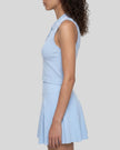 Mid body side view of a model wearing the TrackLine Court Polo Tank Top in Blue with White