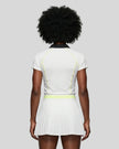 Back view of a female model wearing the TrackLine Court Polo in White