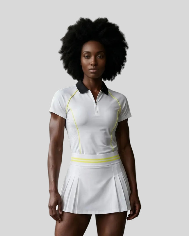 Female model wearing the TrackLine Court Polo in White viewed from the front.