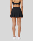 Back view of a model wearing the TrackLine Court Skirt in Black.