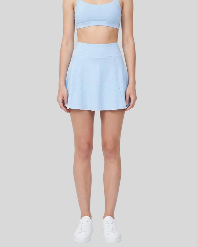 Model wearing the TrackLine Court Skirt in Blue viewed from the front.
