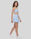 Side view of a model wearing the TrackLine Court Skirt in Blue.