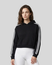 Upper body front view of a woman wearing the Athlesi TrackLine Cropped Hoodie in black