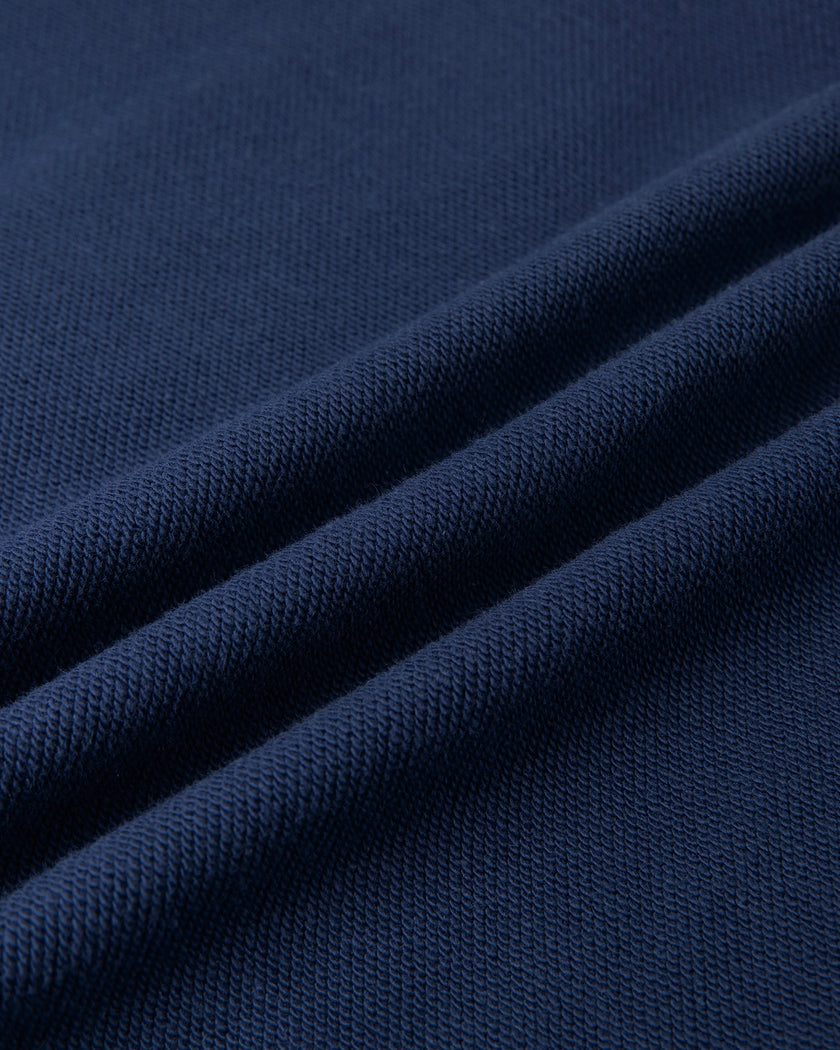 Closeup of the cotton blend fabric texture on the Athlesi TrackLine Cropped Hoodie in blue