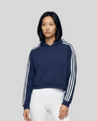 Upper body front view of a woman wearing the Athlesi TrackLine Cropped Hoodie in blue
