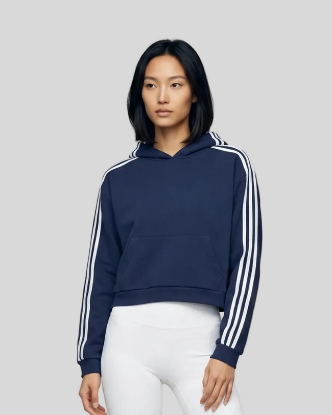 Upper body front view of a woman wearing the Athlesi TrackLine Cropped Hoodie in blue