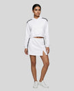 Full body front view of the Athlesi TrackLine Cropped Hoodie in white styled with the TrackLine Slit Skirt
