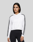 Upper body front view of a woman wearing the Athlesi TrackLine Cropped Hoodie in white