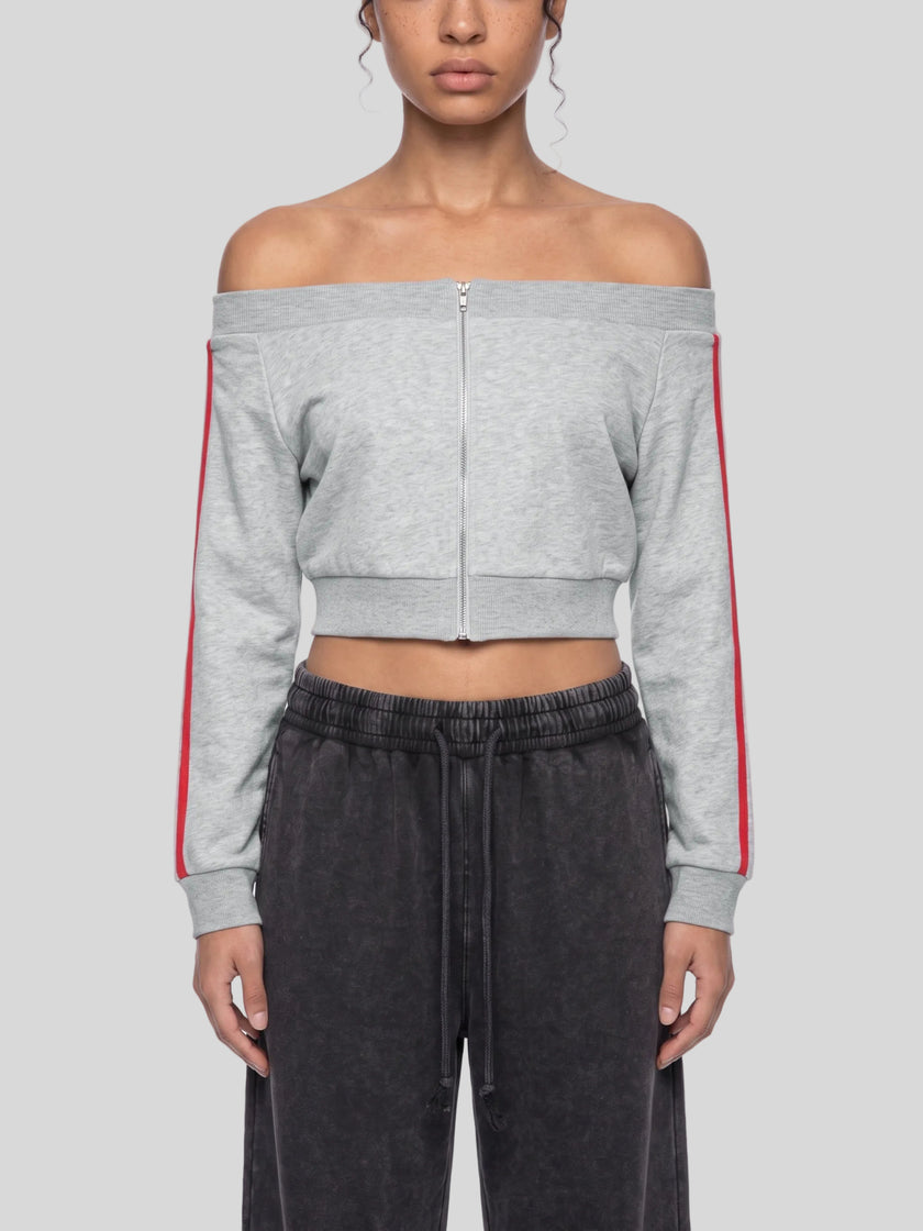 A model wearing a flower gray TrackLine Edge Kacket with red side stripes, paired with dark gray sweatpants.