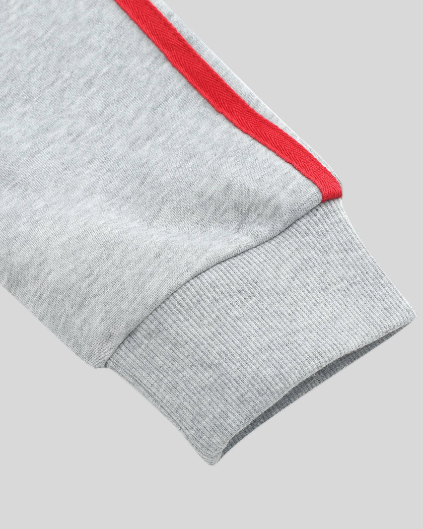 Closeup of contrast red sleeve stripe and ribbed cuff on TrackLine Edge Jacket in Flower Gray