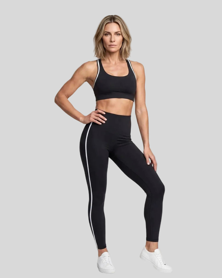 Model wearing the Athlesi TrackLine Edge Leggings in black with white side stripes, front view