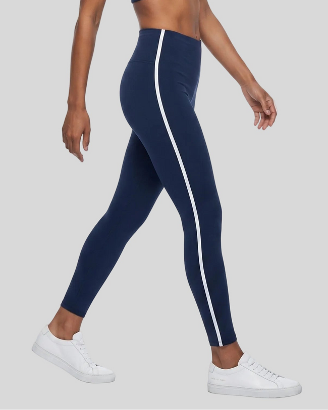 Athlesi TrackLine Edge Leggings in navy blue with white contrast side stripes, lower body side view