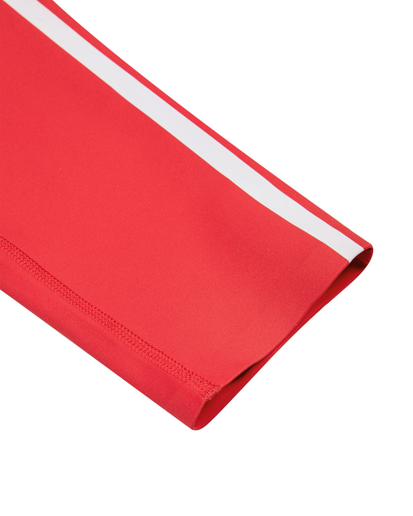 Close-up of the ankle-length hem and white side stripe on the Athlesi TrackLine Edge Leggings in red