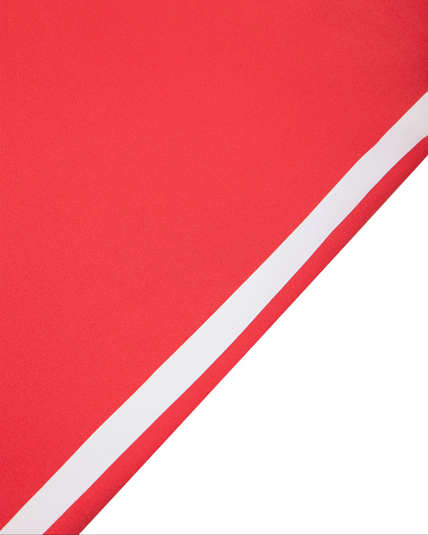 Side close-up of the white contrast stripe on the Athlesi TrackLine Edge Leggings in red