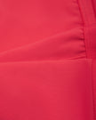 Close-up of the smooth stretch fabric and white contrast trim on the Athlesi TrackLine Edge Sports Bra in red