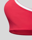 Close-up of the underbust band and fitted hem on the Athlesi TrackLine Edge Sports Bra in red