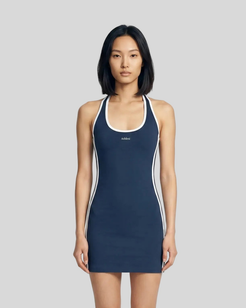 Mid body front view of a woman wearing the Athlesi TrackLine Halter Dress in blue