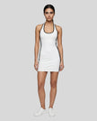Full body front view of a woman wearing the Athlesi TrackLine Halter Dress in white