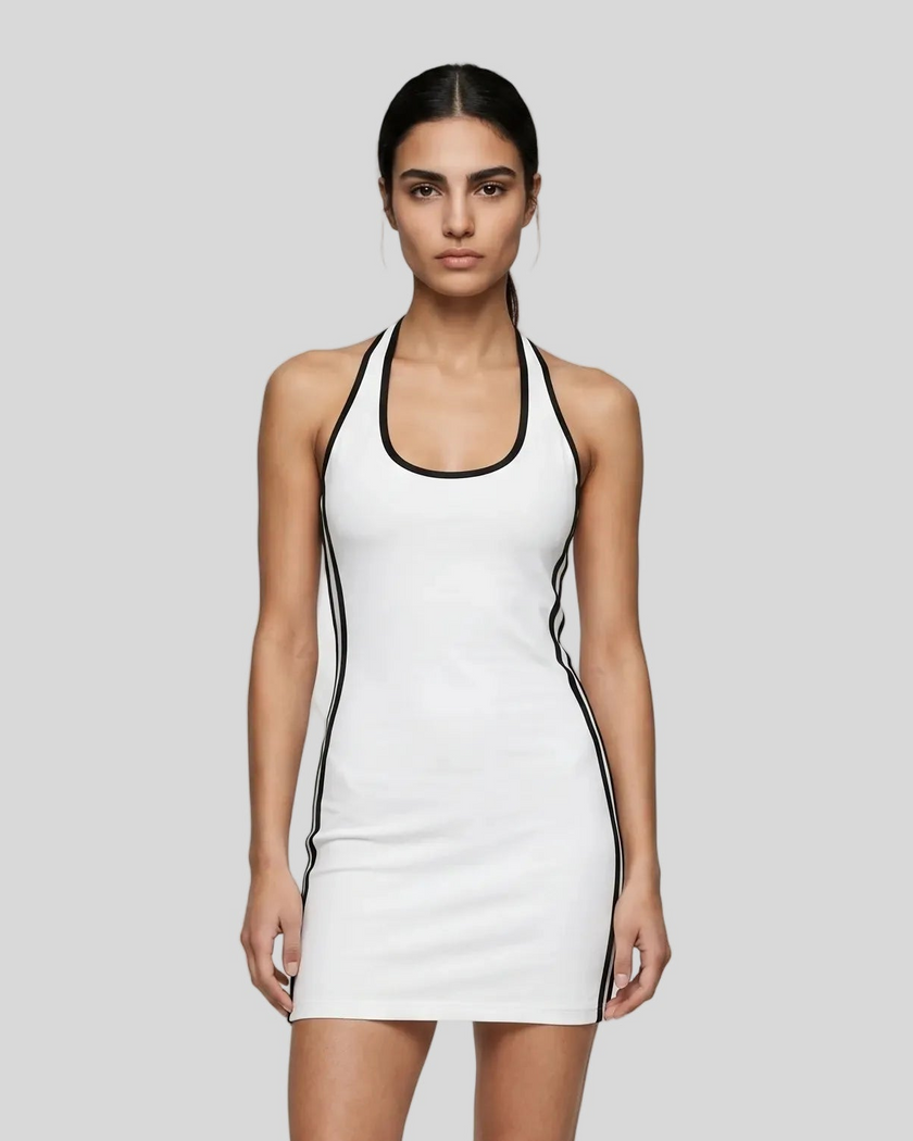 Mid body front view of a woman wearing the Athlesi TrackLine Halter Dress in white