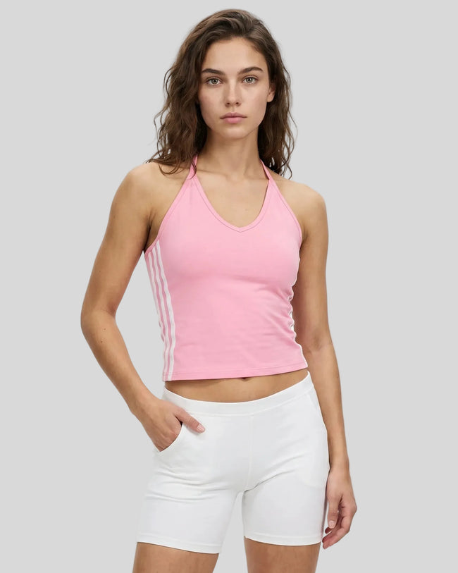 Front angle view of a woman wearing the Athlesi TrackLine Halter Tank in pink and white