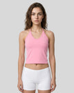 Front view of a woman wearing the Athlesi TrackLine Halter Tank in pink and white
