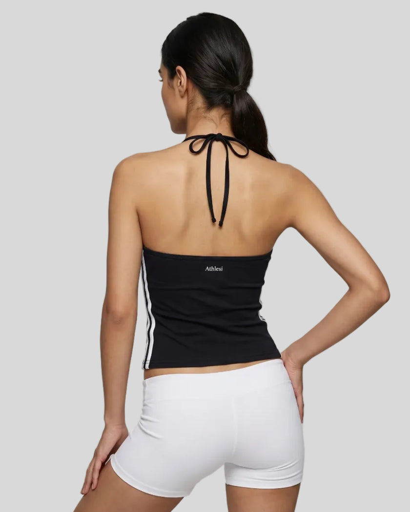 Back view of a woman wearing the Athlesi TrackLine Halter Tank in black and whitek
