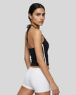 Side view of a woman wearing the Athlesi TrackLine Halter Tank in black and white