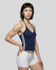 Front angle view of a woman wearing the Athlesi TrackLine Halter Tank in navy blue and white