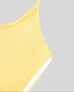 Side seam and arm opening detail closeup of the Athlesi TrackLine Halter Tank in yellow and white