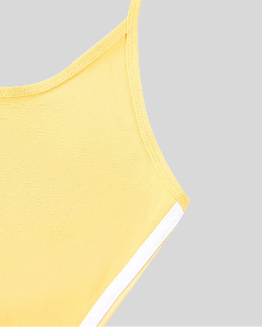 Side seam and arm opening detail closeup of the Athlesi TrackLine Halter Tank in yellow and white