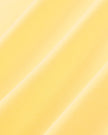 Closeup of the soft stretch fabric on the Athlesi TrackLine Halter Tank in yellow and white