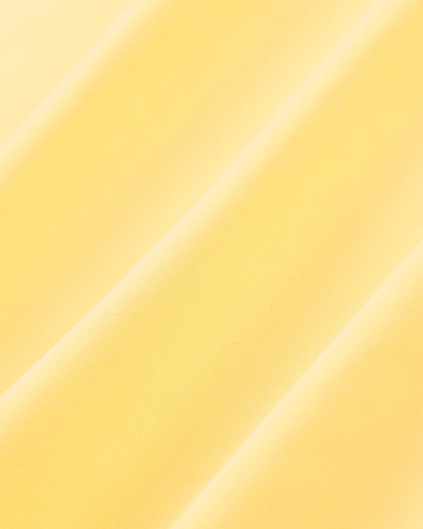 Closeup of the soft stretch fabric on the Athlesi TrackLine Halter Tank in yellow and white