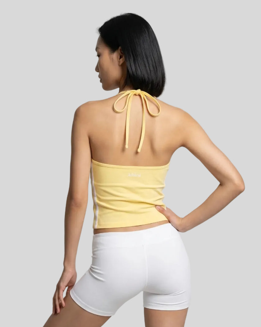 Back view of a woman wearing the Athlesi TrackLine Halter Tank in yellow and white